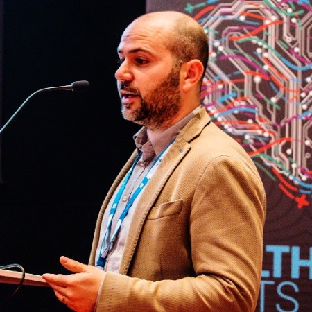Alberto Scarpa speaking at a conference